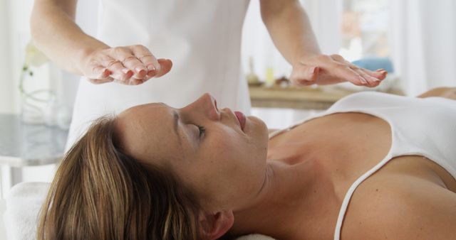 Woman Receiving Reiki Therapy in Wellness Center - Download Free Stock Images Pikwizard.com