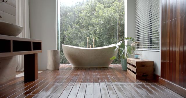 Great for articles or blogs on modern home interior design, showcasing the combination of rustic and modern aesthetics in bathroom spaces. Useful for promoting relaxation and wellness content, emphasizing tranquility and natural surroundings within living spaces.
