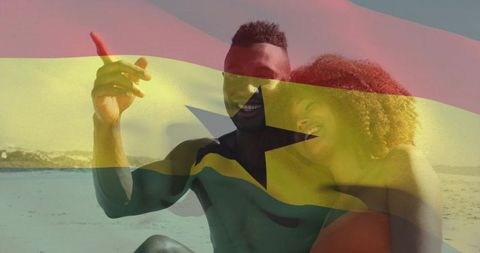 Ghana flag overlay on happy black couple enjoying sunny beach vacation and national pride
