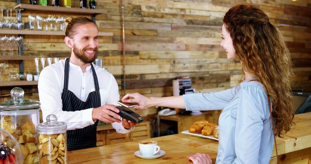 Barista Accepting Contactless Payment from Smiling Customer - Download Free Stock Photos Pikwizard.com