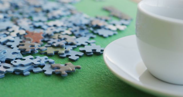 Image of puzzles and cups of coffee on green table - Download Free Stock Photos Pikwizard.com