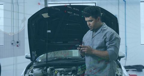 Mechanic Using Smartphone for Automotive Diagnostics in Workshop