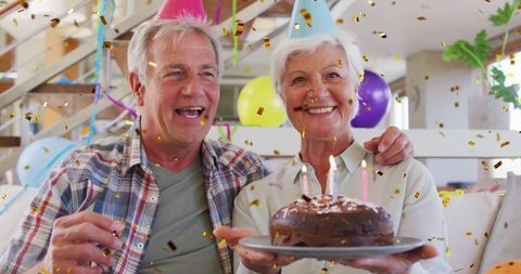 Elderly Couple Celebrating Birthday with Cake and Joy