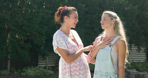 Pregnant friends chatting outdoors in garden