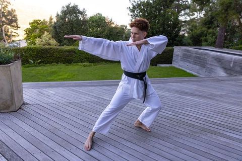 Martial artist practicing kung fu poses in outdoor haven