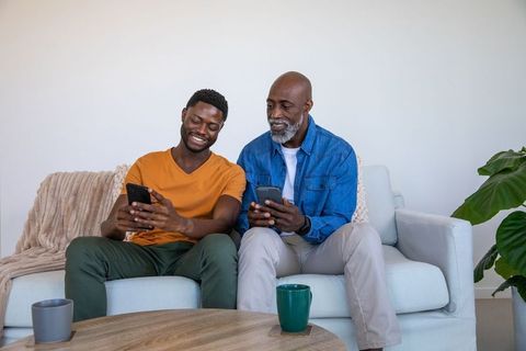 Father and Son Bonding Over Smartphones at Home