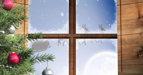 Santa Claus Sleigh with Reindeer Seen Through Frosted Window