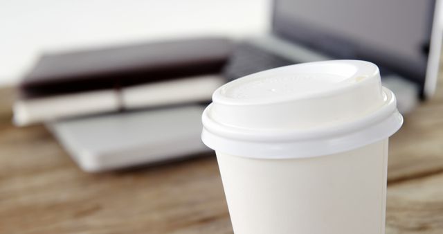 Takeout Coffee Cup on Work Desk with Laptop and Notepads - Download Free Stock Images Pikwizard.com