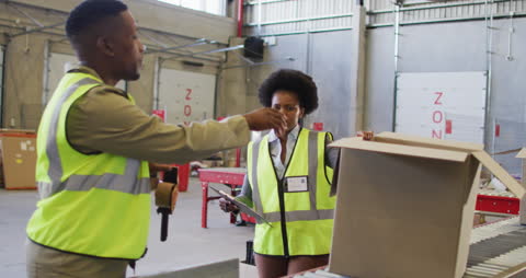 Warehouse Workers Preparing Packages for Shipment