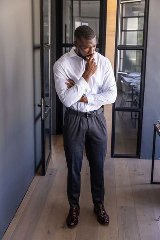 Corporate professional contemplating in modern office