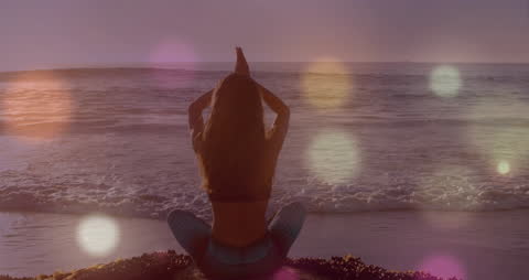 Serene Meditation at the Ocean During Sunset with Bokeh Effects
