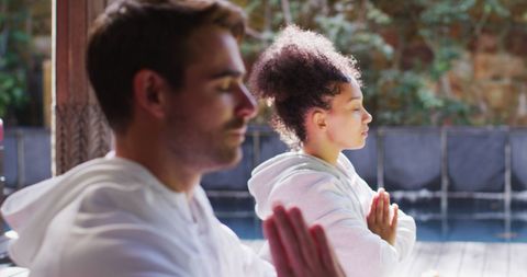 Biracial Couple Meditating Together in Serene Setting