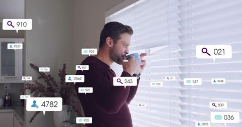Man drinking coffee while peeking through blinds with floating social notification badges