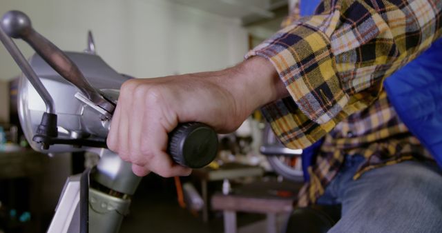 Hand Holding Handlebar in Workshop Setting - Download Free Stock Images Pikwizard.com