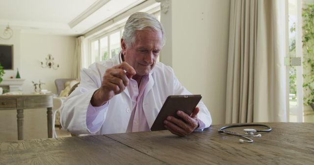 Senior Male Doctor Using Tablet Computer in Office - Download Free Stock Images Pikwizard.com