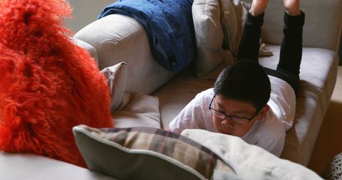 Child Engaging with Tablet on Comfortable Sofa