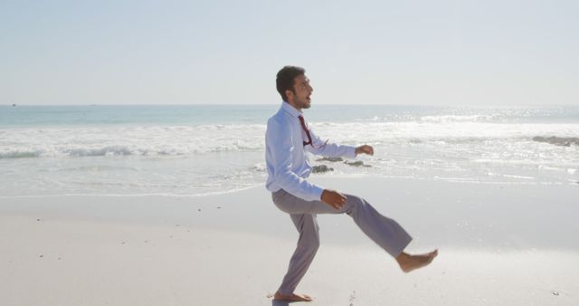 Businessman Walking on Beach Enjoying Relaxed Work Day - Download Free Stock Images Pikwizard.com