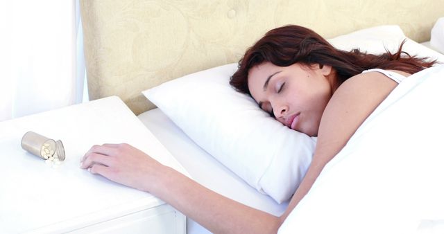 Young Woman Sleeping in Bed Next to Spilled Pill Bottle - Download Free Stock Images Pikwizard.com