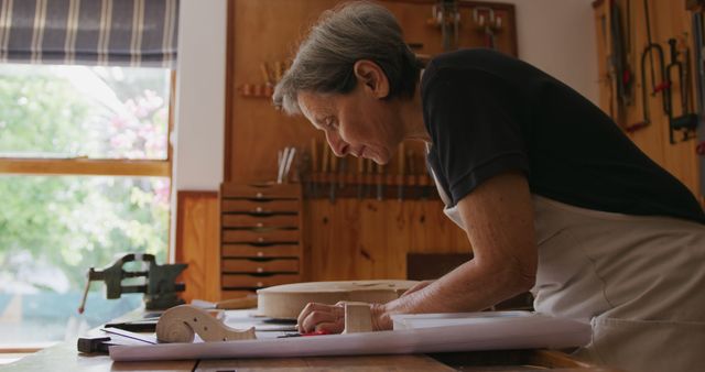 Senior Craftsperson Working in Wood Workshop on Plan - Download Free Stock Images Pikwizard.com