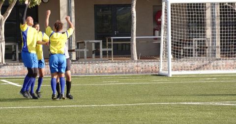 Joyful Soccer Team Celebrating Victory on Field