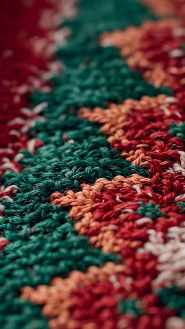 Vertical close-up panning across colorful woven rug, revealing textured yarn pattern