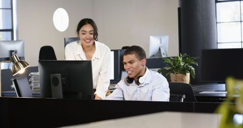 Business Colleagues Collaborating on Computer Project in Modern Office