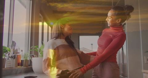 Mother and Daughter Bonding in Sunlit Kitchen