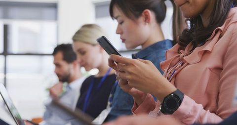 Businesswoman Scrolling Smartphone at Conference Meeting