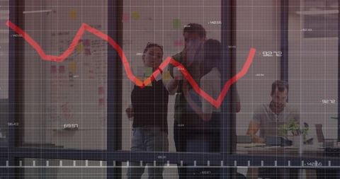 Coworkers analyzing red line chart in meeting room