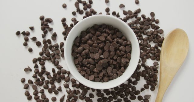 Bowl of Dark Chocolate Chips with Wooden Spoon on White Surface - Download Free Stock Images Pikwizard.com