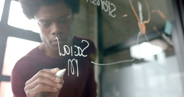 Focused Man Writing on Transparent Board with Marker - Download Free Stock Images Pikwizard.com