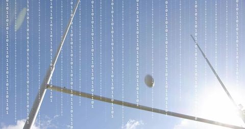 Soaring football arcing through goalposts with digital binary overlay and lens flare