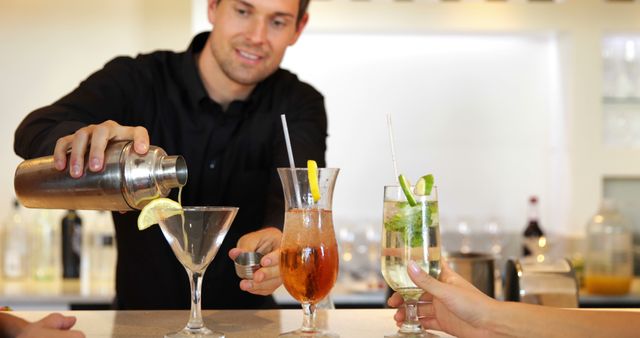 Bartender Mixing Drinks at Modern Bar for Customers - Download Free Stock Images Pikwizard.com