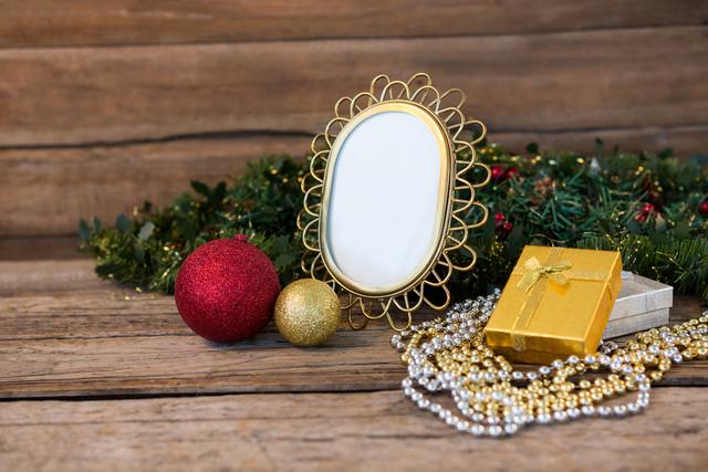 Perfect for holiday-themed designs, greeting cards, and festive advertisements. The image showcases a rustic wooden background adorned with Christmas decorations, including a gold frame, baubles, garland, and wrapped gifts, creating a warm and festive atmosphere.