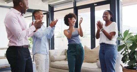 Business Team Celebrating Success in Modern Office Environment