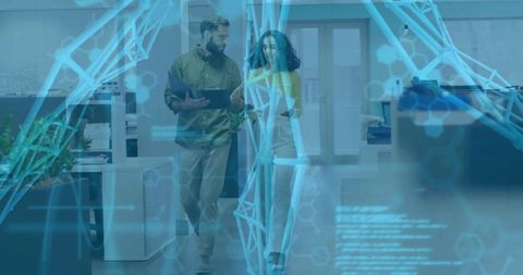 Colleagues walking and collaborating with tablet, holographic data overlay in modern office