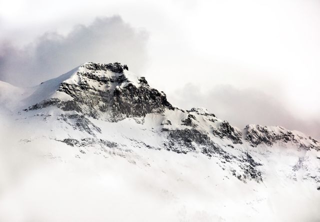 Snow-Covered Mountain Peak with Cloudy Sky - Download Free Stock Photos Pikwizard.com