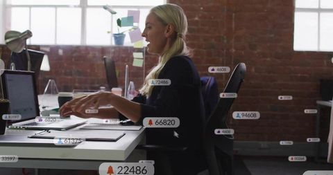 Professional Analyzing Data on Laptop in Modern Office Environment