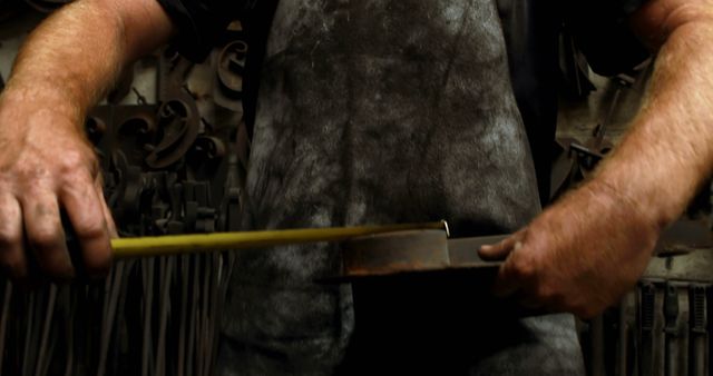 Close-Up of Blacksmith Measuring Metal with Yellow Tape Measure - Download Free Stock Images Pikwizard.com