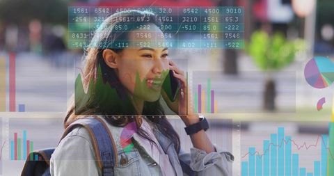 Asian woman walking and speaking on smartphone with analytics overlays, urban commuter