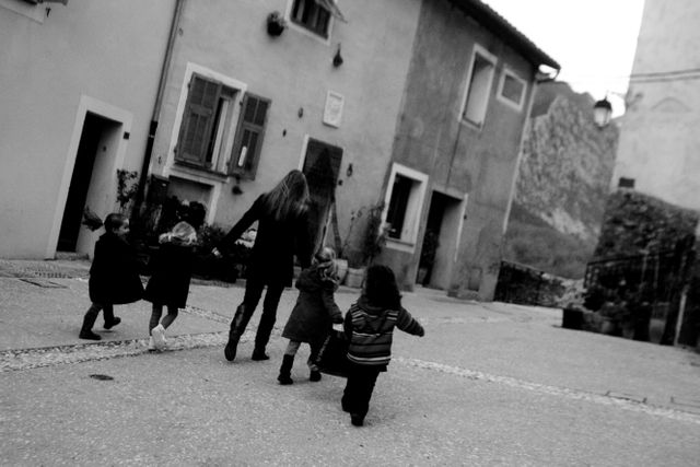 Black and white photo of children walking, guarded by an adult - Download Free Stock Images Pikwizard.com
