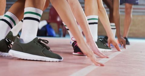 Athletes Ready to Race on Indoor Track Showing Determination