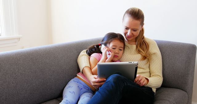 Mother and Daughter Spending Time Together with Tablet on Couch - Download Free Stock Images Pikwizard.com