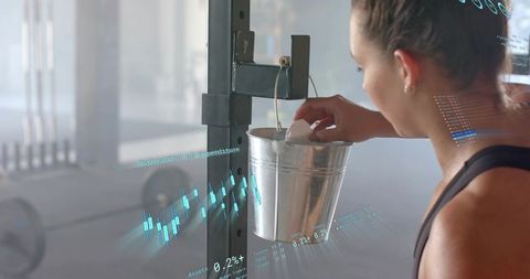 Athlete reaching for chalk bucket while preparing for lift, gym training with data overlay