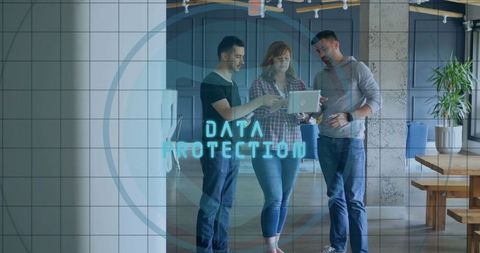 Professionals Analyzing Data Protection on Laptop in Modern Workspace
