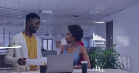 Collaborating Professionals Analyzing Data at Modern Workspace