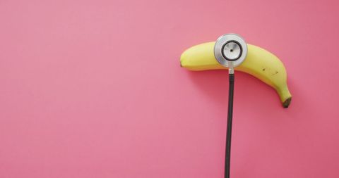 Banana and Stethoscope on Pink with Copy Space