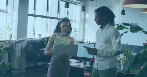 Colleagues Analyzing Business Data with Graphics in Modern Workspace