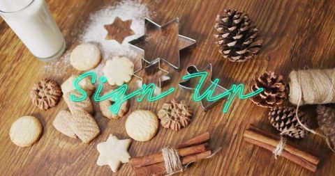 Rustic holiday cookie baking flatlay with star cutters, cinnamon sticks and milk