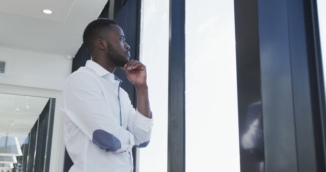 Contemplative Businessman Looking Out Glass Windows - Download Free Stock Images Pikwizard.com